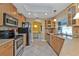 Kitchen featuring stainless appliances, light wood cabinets, tile flooring, and dining area at 295 Porto Alegre St, Punta Gorda, FL 33983