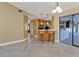 Neutral living room with vaulted ceiling, fan, tile flooring, and view of kitchen and hallway at 295 Porto Alegre St, Punta Gorda, FL 33983