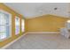 Bright living room featuring tile floors, a vaulted ceiling with fan, and natural lighting from the windows at 295 Porto Alegre St, Punta Gorda, FL 33983