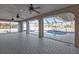 An interior view of a home's lanai with tile floors, ceiling fans, and a screened-in pool with a pool deck at 295 Porto Alegre St, Punta Gorda, FL 33983