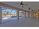 An interior view of a home's lanai leads to the screened-in pool with pool deck and ceiling fans at 295 Porto Alegre St, Punta Gorda, FL 33983