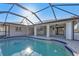 The home's screened-in pool features a pool deck with surrounding greenery and blue skies at 295 Porto Alegre St, Punta Gorda, FL 33983