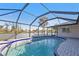 An aerial, wide shot shows a screened-in pool with a pool deck surrounded by greenery at 295 Porto Alegre St, Punta Gorda, FL 33983