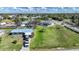 Expansive aerial view of a property showcasing a spacious lot, mature trees, and surrounding neighborhood at 3120 Wisteria Pl, Punta Gorda, FL 33950