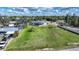 Expansive aerial view of a property showcasing a spacious lot, mature trees, and surrounding neighborhood at 3120 Wisteria Pl, Punta Gorda, FL 33950