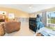 Bright living room with tile floors, showing furniture, and natural light at 3120 Wisteria Pl, Punta Gorda, FL 33950