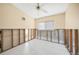 Bright room featuring tiled floors, a ceiling fan, a window and partially renovated walls at 3120 Wisteria Pl, Punta Gorda, FL 33950