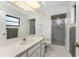 Bathroom features a large mirror, vanity with sink, and a walk-in shower at 349 Grenada St, Port Charlotte, FL 33948