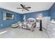 Spacious bedroom with tile floors, ceiling fan, and large windows at 349 Grenada St, Port Charlotte, FL 33948