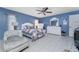 Well-lit bedroom features tile floors, ceiling fan, and large windows at 349 Grenada St, Port Charlotte, FL 33948