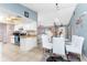 View of the bright kitchen and dining area featuring white appliances and white furnishings at 349 Grenada St, Port Charlotte, FL 33948