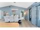 Open dining area with a glass table, white chairs, neutral tile flooring, and sliding glass doors to the outside at 349 Grenada St, Port Charlotte, FL 33948