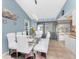 Dining area featuring a glass table, white chairs, and sliding glass doors for natural light at 349 Grenada St, Port Charlotte, FL 33948