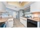 Kitchen featuring wood countertop, white cabinets, stainless steel sink and a view into the dining area at 349 Grenada St, Port Charlotte, FL 33948