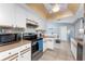 Bright kitchen features white cabinetry, stainless steel appliances, and a unique ceiling fixture at 349 Grenada St, Port Charlotte, FL 33948