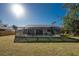 Beautiful view of the screened-in pool and backyard, ideal for relaxation and entertainment at 349 Grenada St, Port Charlotte, FL 33948