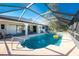 Private screened-in pool area offering relaxation and entertainment with an outdoor dining area at 349 Grenada St, Port Charlotte, FL 33948