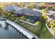 Aerial view of a home with pool, screened in porch, and a dock on a sunny day at 3612 Licata Ct, Punta Gorda, FL 33950