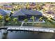 Aerial view of a waterfront home with pool, screened in porch, and a dock on a sunny day at 3612 Licata Ct, Punta Gorda, FL 33950