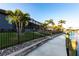 Backyard showing view of the water, a fenced in yard and tropical landscaping at 3612 Licata Ct, Punta Gorda, FL 33950