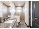 Bright bathroom featuring granite countertop, sleek gray cabinetry, and stylish tiled walk-in shower at 3612 Licata Ct, Punta Gorda, FL 33950