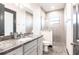 Modern bathroom featuring granite countertop, sleek gray cabinetry, and stylish tiled walk-in shower at 3612 Licata Ct, Punta Gorda, FL 33950