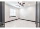 Bright, empty bedroom with white walls, white tiled floor and ceiling fan at 3612 Licata Ct, Punta Gorda, FL 33950