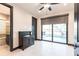 Bedroom with a water view through sliding glass doors, adjacent bathroom, ceiling fan, and tile flooring at 3612 Licata Ct, Punta Gorda, FL 33950