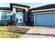 Home exterior featuring a paver driveway, two-car garage, and well-maintained front lawn at 3612 Licata Ct, Punta Gorda, FL 33950