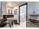 A bright kitchenette area with modern appliances and view through doorway into kitchen area at 3612 Licata Ct, Punta Gorda, FL 33950