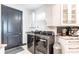 Well-equipped laundry room with modern washer and dryer, sink, and white shaker cabinetry at 3612 Licata Ct, Punta Gorda, FL 33950