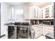 Bright laundry room featuring front load washer/dryer, granite counters, and ample white cabinetry at 3612 Licata Ct, Punta Gorda, FL 33950