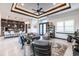 Open living space featuring a tray ceiling, tiled floors, and an adjacent kitchen with counter seating at 3612 Licata Ct, Punta Gorda, FL 33950