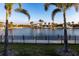 Scenic water view with palm trees and a black fence, perfect for relaxation at 3612 Licata Ct, Punta Gorda, FL 33950