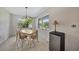 Bright dining area featuring a wooden table with seating and natural light from the windows at 3615 Sleepy Hollow Ln, Punta Gorda, FL 33950