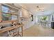 Bright kitchen area features tile flooring, natural light from window, and view into the dining area at 3615 Sleepy Hollow Ln, Punta Gorda, FL 33950