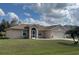 Charming single-story home featuring a manicured lawn and attached two-car garage at 376 Vitorio St, Punta Gorda, FL 33983