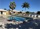 Community pool has clear blue water, lounge chairs, and is surrounded by palm trees at 4000 Bal Harbor Blvd # 527, Punta Gorda, FL 33950