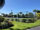 Outdoor tennis courts are surrounded by lush landscaping and greenery at 4000 Bal Harbor Blvd # 527, Punta Gorda, FL 33950