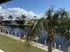 Scenic view of a waterfront canal featuring docks, boats, and lush palm trees at 4000 Bal Harbor Blvd # 527, Punta Gorda, FL 33950