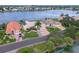Aerial shot of waterfront homes, showcasing lush landscaping and beautiful lake views at 10256 Shadow Run Ct, Punta Gorda, FL 33955