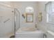 Bright bathroom featuring a tiled shower, tub, and decorative details around the window at 10256 Shadow Run Ct, Punta Gorda, FL 33955