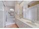 Bathroom featuring dual sinks, tile floors, and a bathtub with a glass door shower at 10256 Shadow Run Ct, Punta Gorda, FL 33955