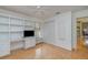 Bedroom featuring hardwood floors, built in bookcase, and fan at 10256 Shadow Run Ct, Punta Gorda, FL 33955