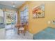 Bright breakfast nook features a charming table set, large window, and a door to the outside patio at 10256 Shadow Run Ct, Punta Gorda, FL 33955