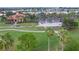 Aerial view of the clubhouse with golf carts parked, showcasing lush green surroundings and well-maintained grounds at 10256 Shadow Run Ct, Punta Gorda, FL 33955