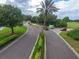 View of the community entrance with well-maintained landscaping, a guardhouse, and a glimpse of the surrounding area at 10256 Shadow Run Ct, Punta Gorda, FL 33955