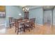 Formal dining room featuring hardwood floors, chandelier lighting, and elegant decor at 10256 Shadow Run Ct, Punta Gorda, FL 33955