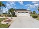 Charming single-story home featuring a two-car garage, tile roof, and well-manicured landscaping at 10256 Shadow Run Ct, Punta Gorda, FL 33955