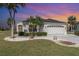 Charming single Gathering home featuring a barrel tile roof and a well manicured lawn with decorative rock at 10256 Shadow Run Ct, Punta Gorda, FL 33955